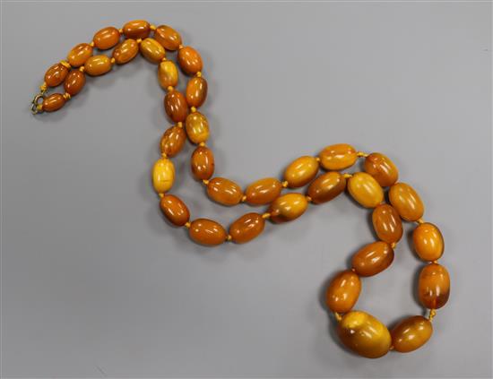 A single strand graduated oval amber bead necklace, goss weight 50 grams, 66cm.